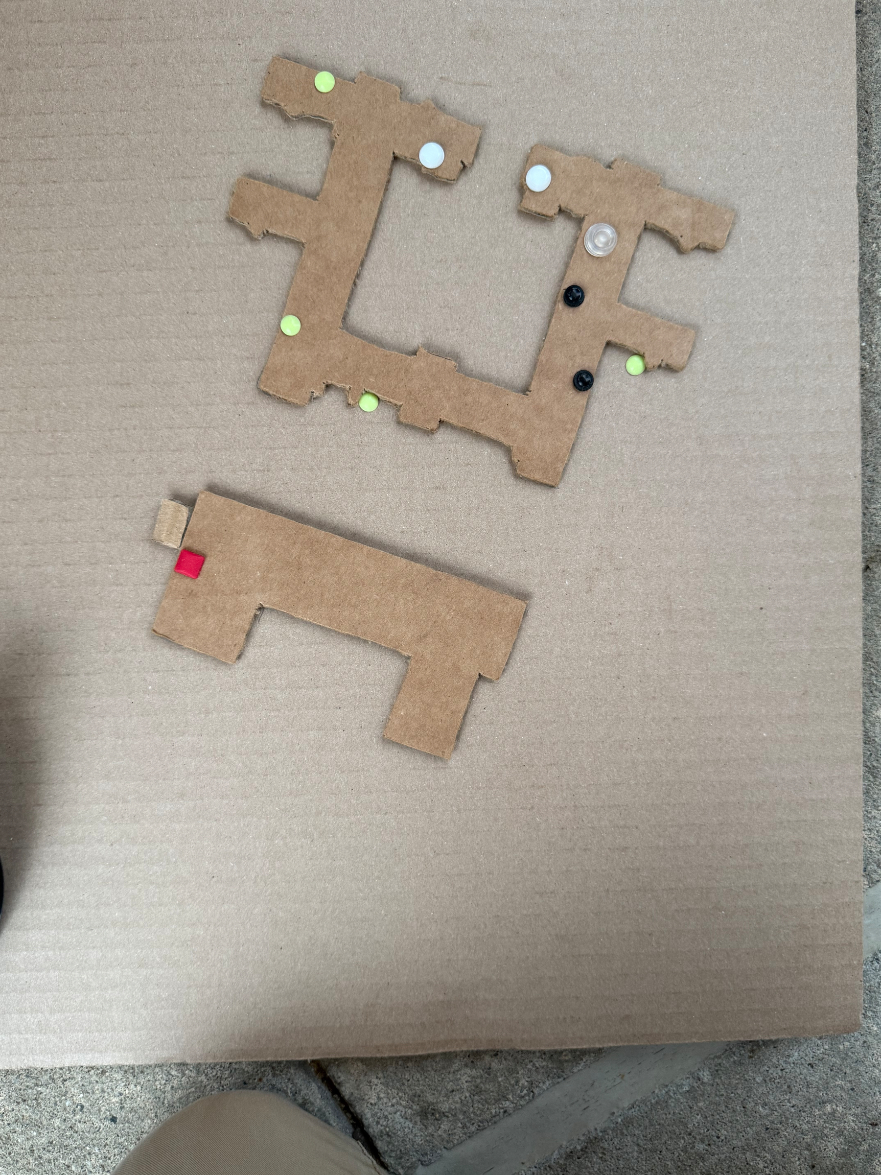 Cardboard map of the dormitories at Perkins. It's an square buildings with lots of protusions around the edges and a large courtyard. Bump dots are placed around the edges of the buidling. 